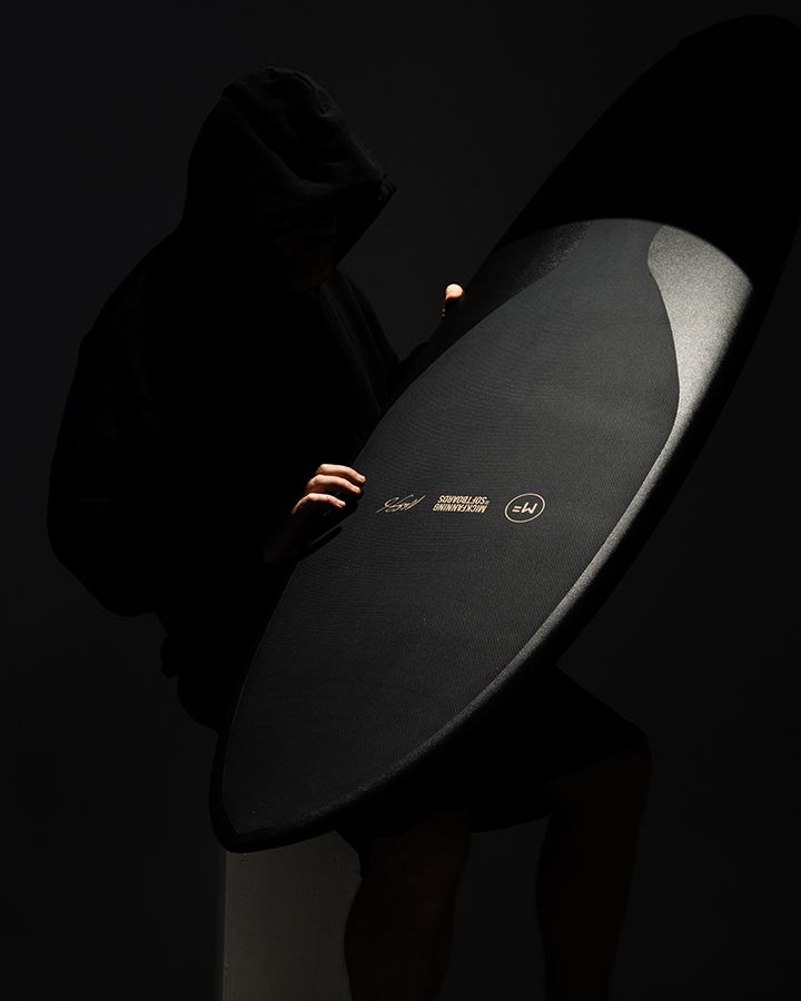 Close detail of a black Mick Fanning Softboard deck and logo